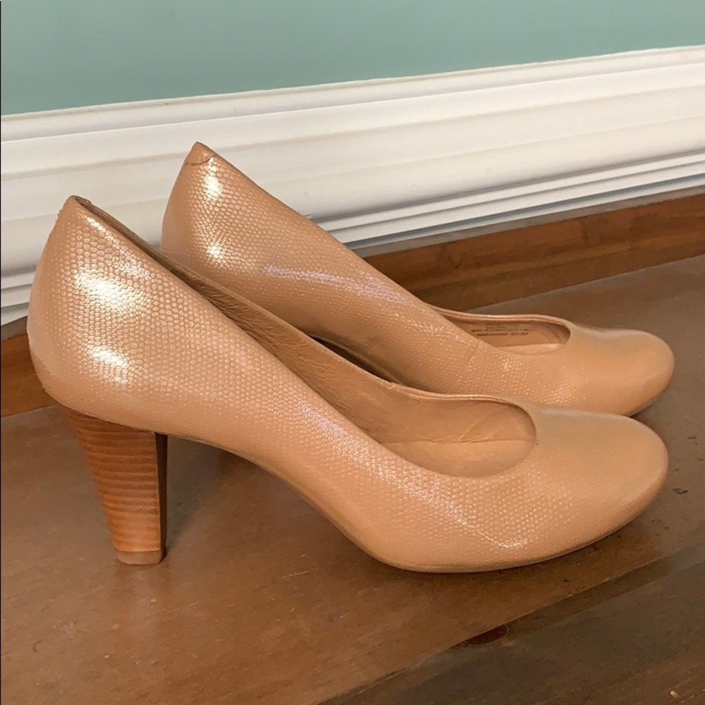 Tan colored pumps with wooden heels.